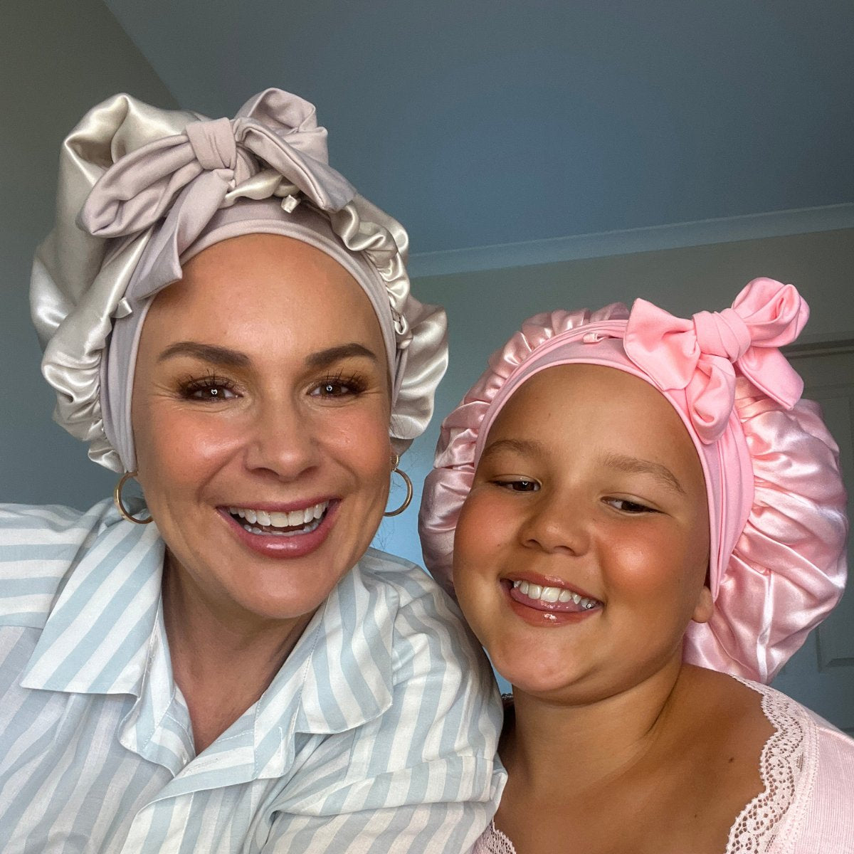 woman and child wearing silk cloud bonnets to protect curls overnight 