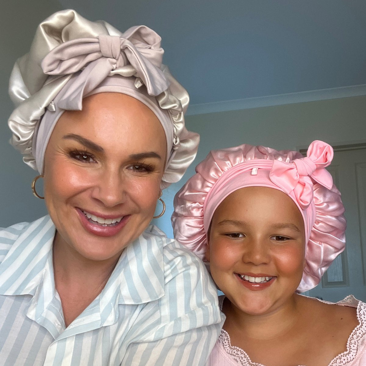 Woman and young lady wearing silk curl protecting Cloud Bonnets