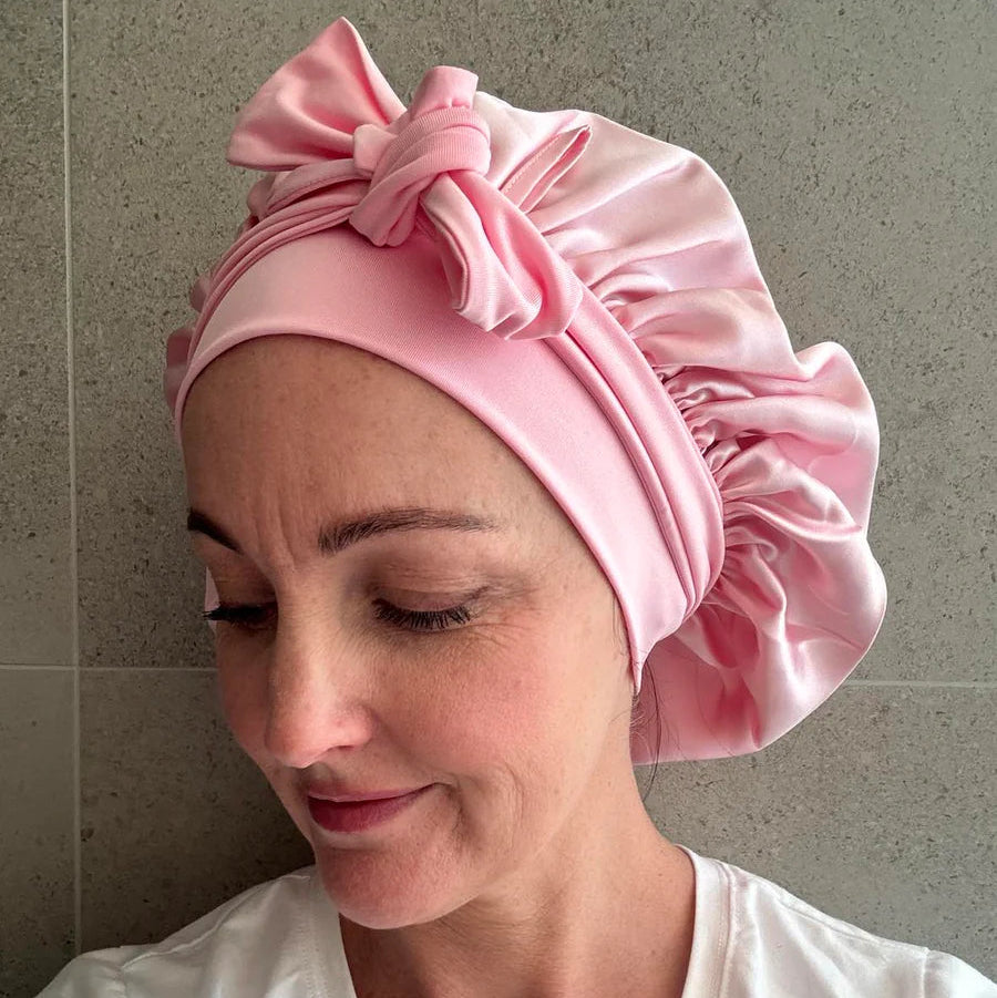 Female wearing blush pink silk cloud bonnet