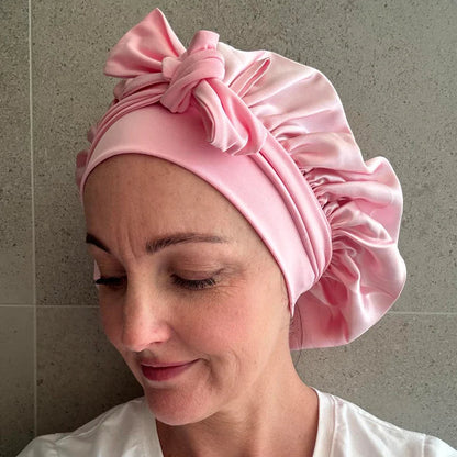 Female wearing blush pink silk cloud bonnet